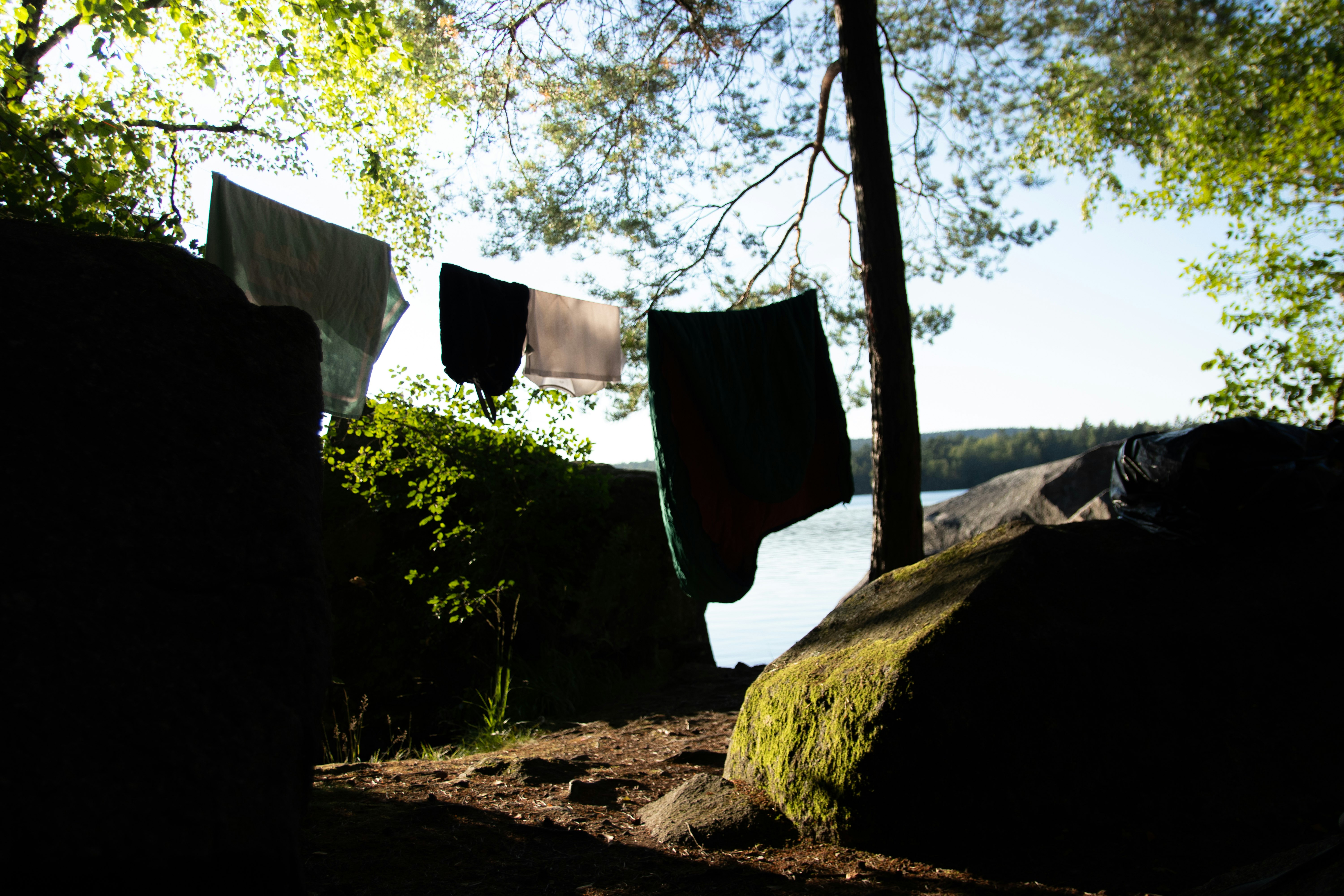 black pants hanging on white wooden fence